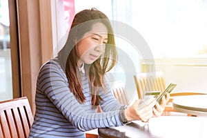 Woman holding credit card for shopping online. Woman paying with debit card for shopping online. Woman paying with credit card on