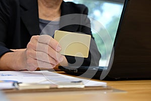 woman holding credit card using computer for online shopping. bu
