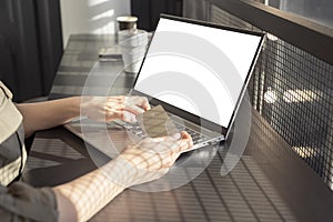 Woman holding credit card and using laptop mockup for online shopping or booking. Female hands closeup