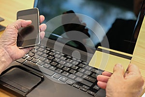 woman holding credit card using smart phone for online shopping.