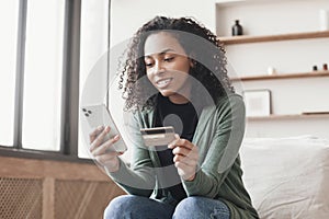 Woman holding credit card and using smartphone at home, businesswoman shopping online, e-commerce, internet banking