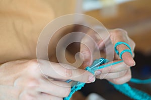 Woman holding crochet needle. Crafts and hobbies