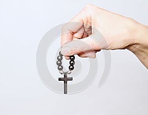 Woman holding a cross with rosary beads stock photo