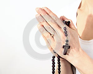 Woman holding a cross with rosary beads stock photo