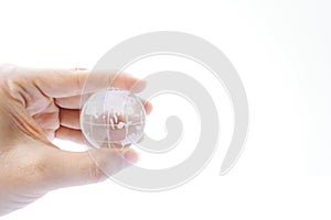 Woman holding crystal earth ball on white background