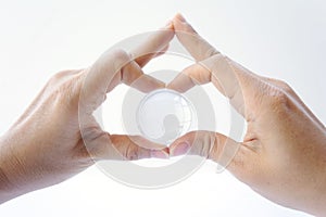 Woman holding crystal earth ball on white background