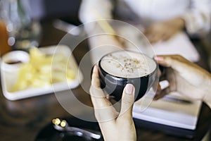 Woman holding a cup of cappuccino