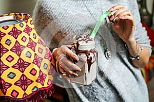 Woman Holding a Cup of Chocolate Milkshake