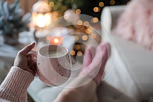 Woman holding cup of cocoa at home, closeup. Christmas mood