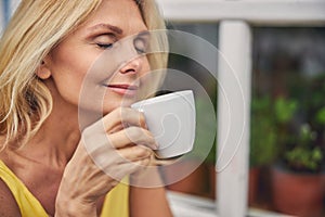 Woman holding a cup of hot beverage