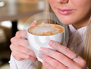 Woman holding a cup of hot drink