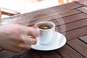 A Woman Holding a Cup of Turkish Coffee