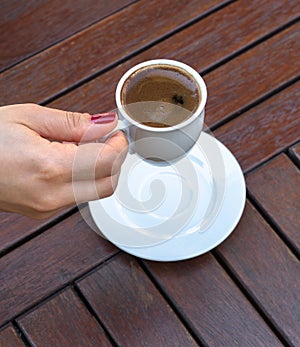 A Woman Holding a Cup of Turkish Coffee