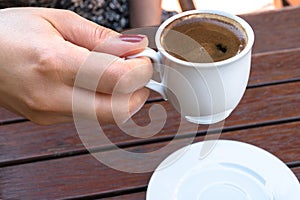 A Woman Holding a Cup of Turkish Coffee