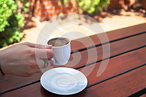 A Woman Holding a Cup of Turkish Coffee