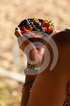 Woman holding a delicious smoothy breakfast bowl