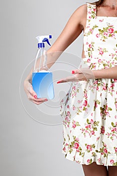 Woman holding a detergent spray