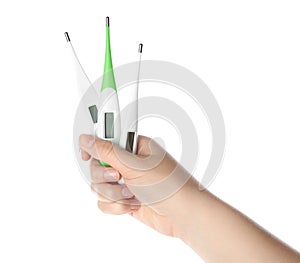 Woman holding different thermometers on background, closeup