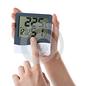 Woman holding digital hygrometer on white background, closeup