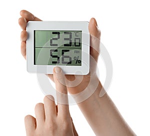 Woman holding digital hygrometer on white background, closeup