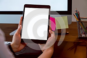 Woman holding digital tablet mockup of blank screen and computer on the table office. Take your screen to put on advertising.