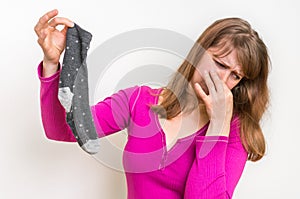 Woman holding dirty stinky socks