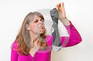 Woman holding dirty stinky socks