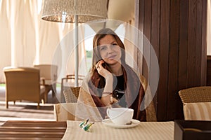 Woman holding a dog in the cafe