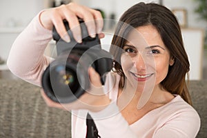 woman holding dslr camera