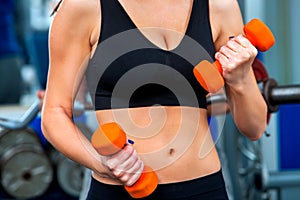 Woman holding dumbbell workout at gym.