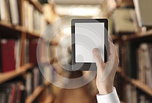 Woman holding e-book reader in library, closeup and space for text