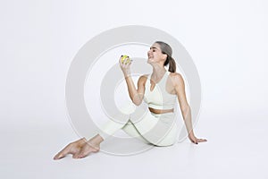 Woman holding and eating fresh green apple on white background. Dieting concept. Healthy lifestyle. Isolated object