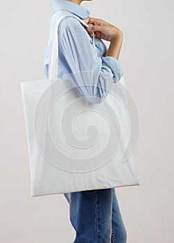 woman holding eco fabric bag isolate on gray