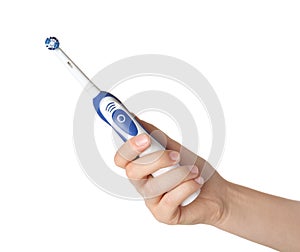 Woman holding electric toothbrush against