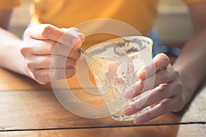 Woman holding empty coffee cup