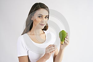 Woman holding a energy efficient light bulb