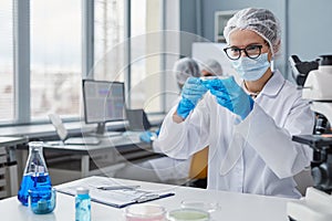 Woman holding experiments in laboratory