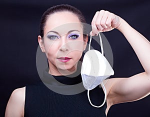 Woman holding a face mask photo