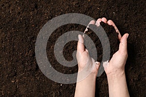 Woman holding fertile soil in hands, closeup. Gardening season