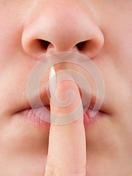 Woman holding finger to lip