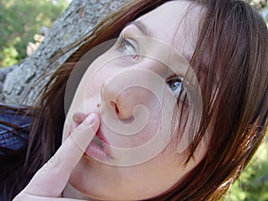 Woman holding finger to mouth