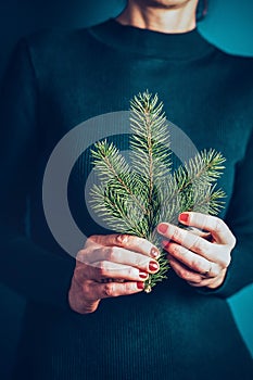 woman holding a fir branch at Christmas