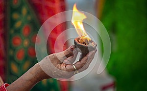 Woman holding fire in her hand as part of a Hindu ritual at Varanasi India