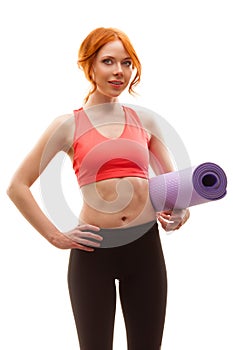 Woman holding fitness mat