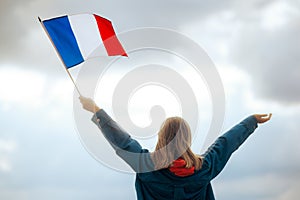 Woman Holding the Flag of France on a Skyscape