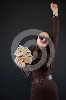 woman holding four aces in her hand isolated on black