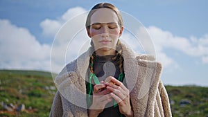 Woman holding fresh egg on green field. Healthy eating sustainable lifestyle