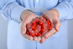 Woman holding fresh goji berries, closeup