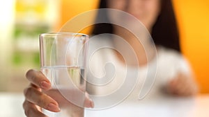 Woman holding fresh water, body hydration, beverage for weight loss, refreshment