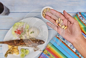 Woman holding a Fried Peruvian corn nut known also as cancha, Selective Focus